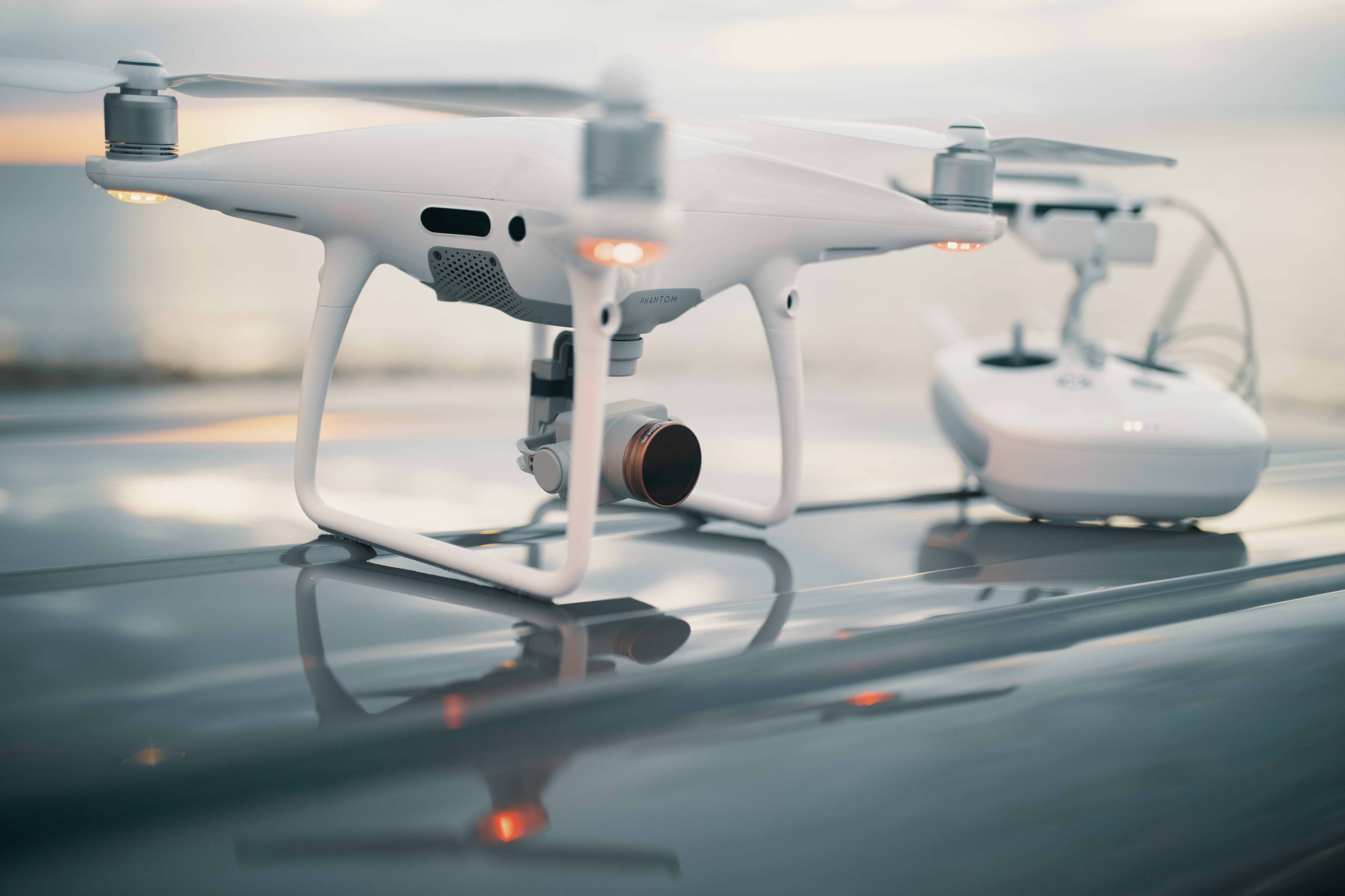 white drone and controller on table